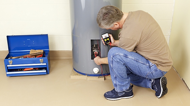 A man working on a hot water tank