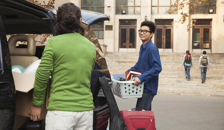 Mother helping student move into university campus