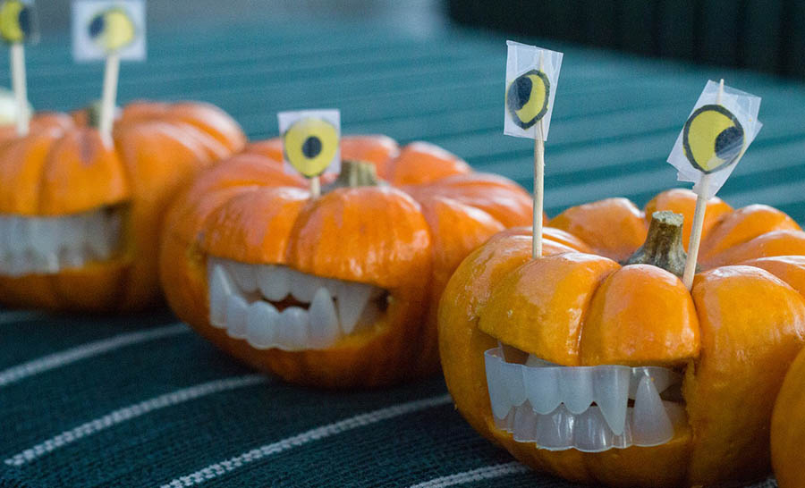 Decorated mini pumpkins with teeth and eyes