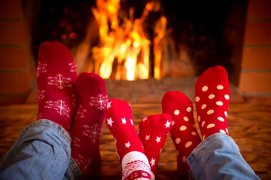 Family with red socks on in front of a fireplace