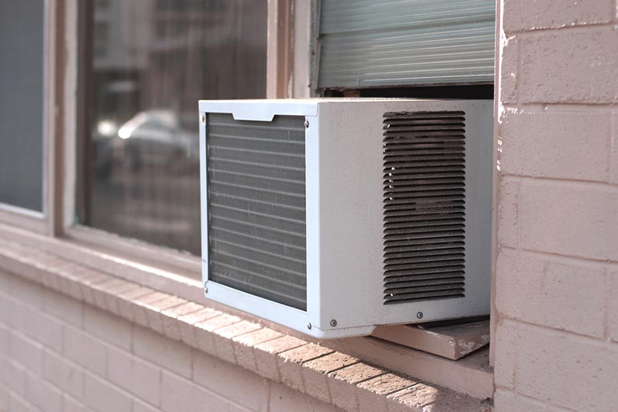 Window air conditioner installed in a brick building