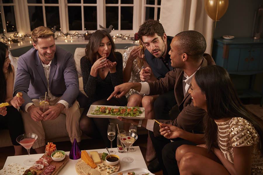 Group of friends talking at a holiday party