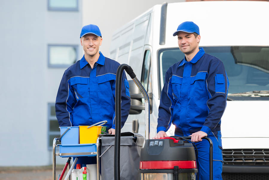 Two working men about to clean up a sewer backup