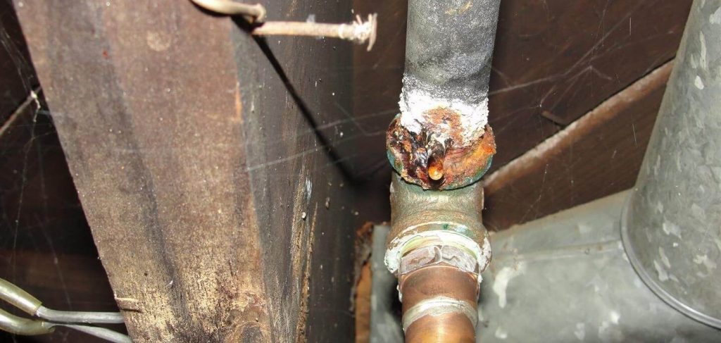 Rusty water drips from galvanized steel plumbing in the home