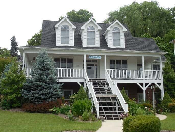 White house with a veranda and large staircase