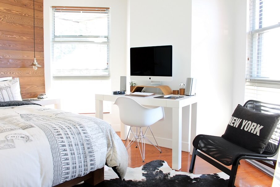 Bright office bedroom with small desk and bed