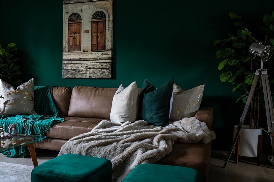 Throw rug and pillows on couch in dark room