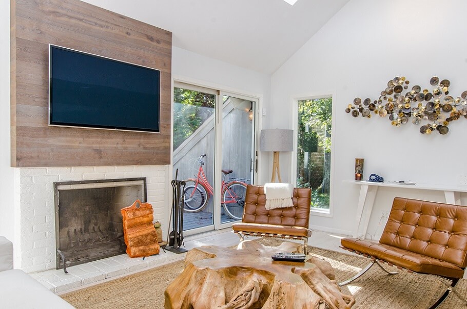 White living room with fireplace and TV