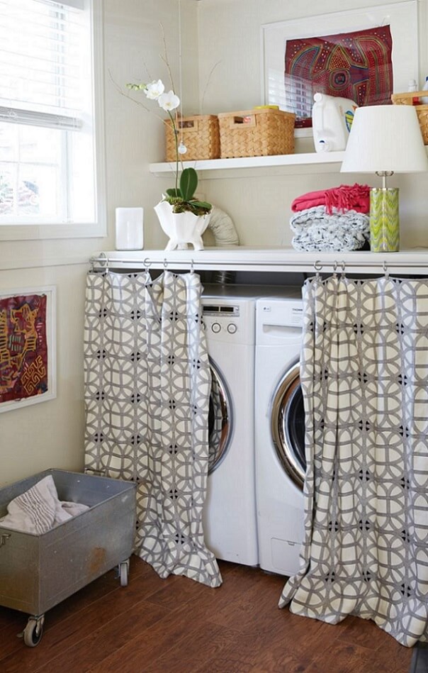 Washer and dryer hidden behind curtain in room