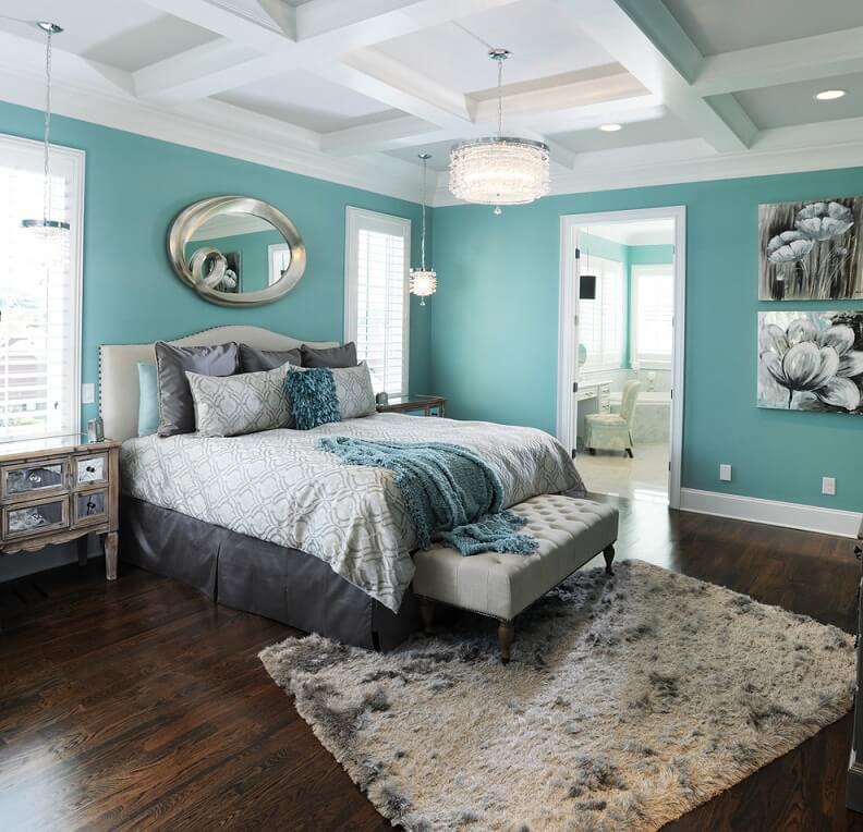 Master bedroom with blue walls and dark hardwood floors