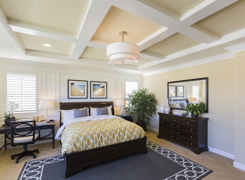 Master bedroom with area rug and unique ceiling