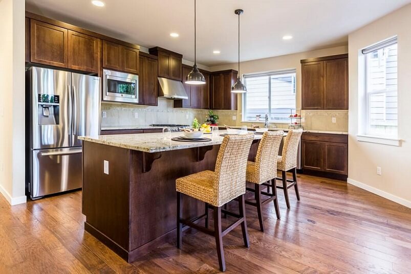 Warm kitchen with island and hardwood floors