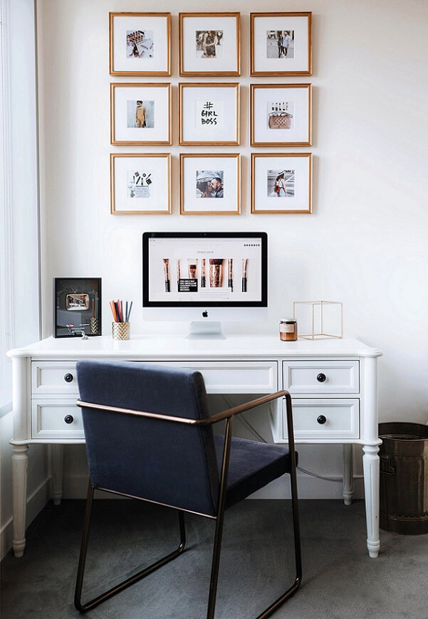 Tall gallery wall display above a home office desk