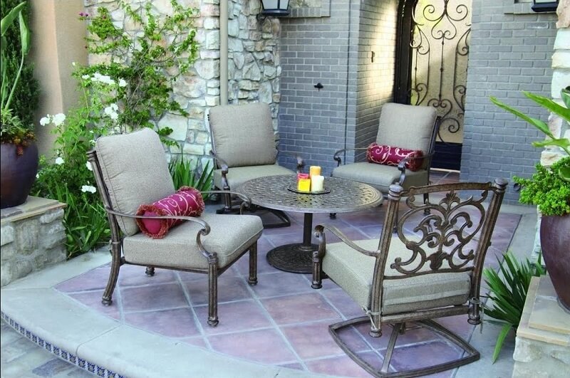 Stone and tile outdoor patio with aluminum chairs and table