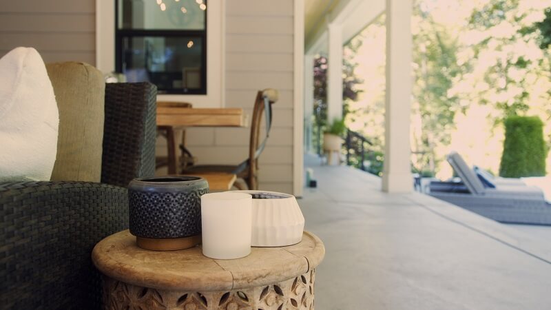 mosquito-repellent candles on a house porch and table