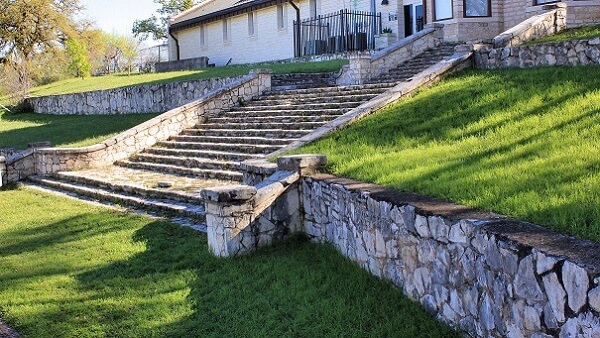 Long stone retaining wall outside a house