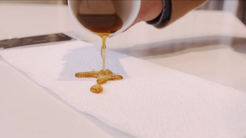 Oil being poured onto stain resistant fabric