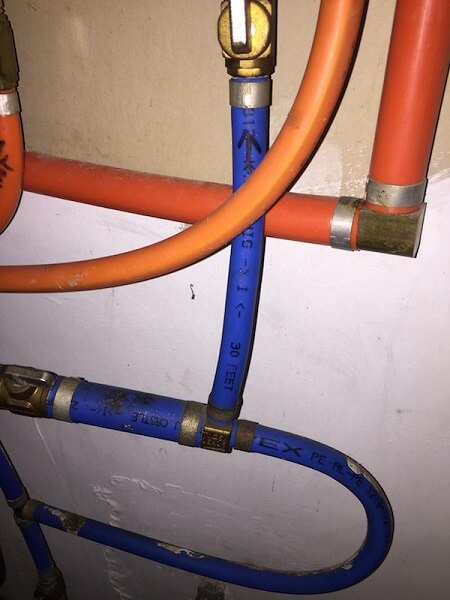 Orange and blue kitec plumbing in a house