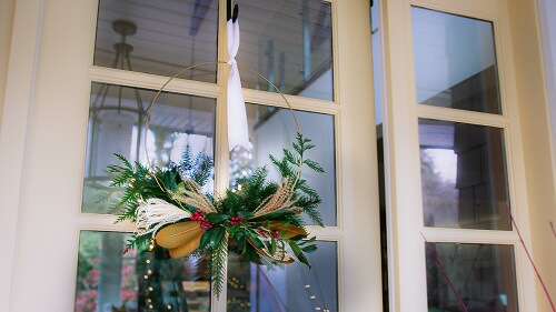 Hanging Christmas wreath on a door