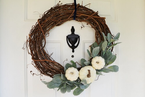 Farmhouse style wreath on a white door