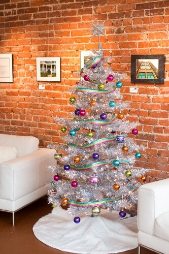 Artificial Christmas tree against a brick wall