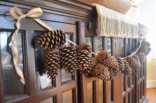 Homemade strung pinecone garland display