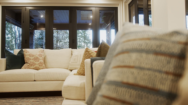 Light and dark pillows arranged on a white couch