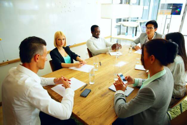 six condo board members sitting around a table