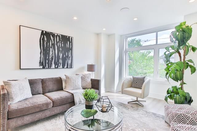 A tidy living room with natural lighting staged for Airbnb photography