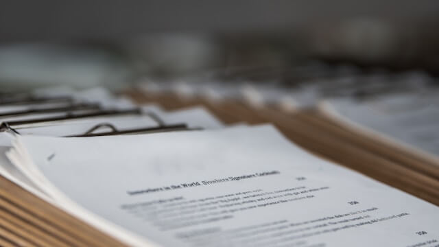 Stack of documents on a wooden table