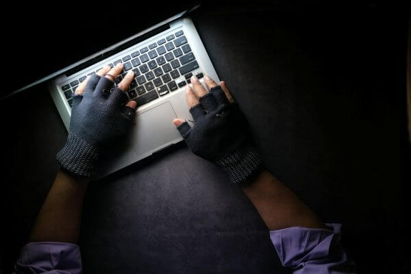 Thumbnail showing a top-down view of gloved hands operating a laptop